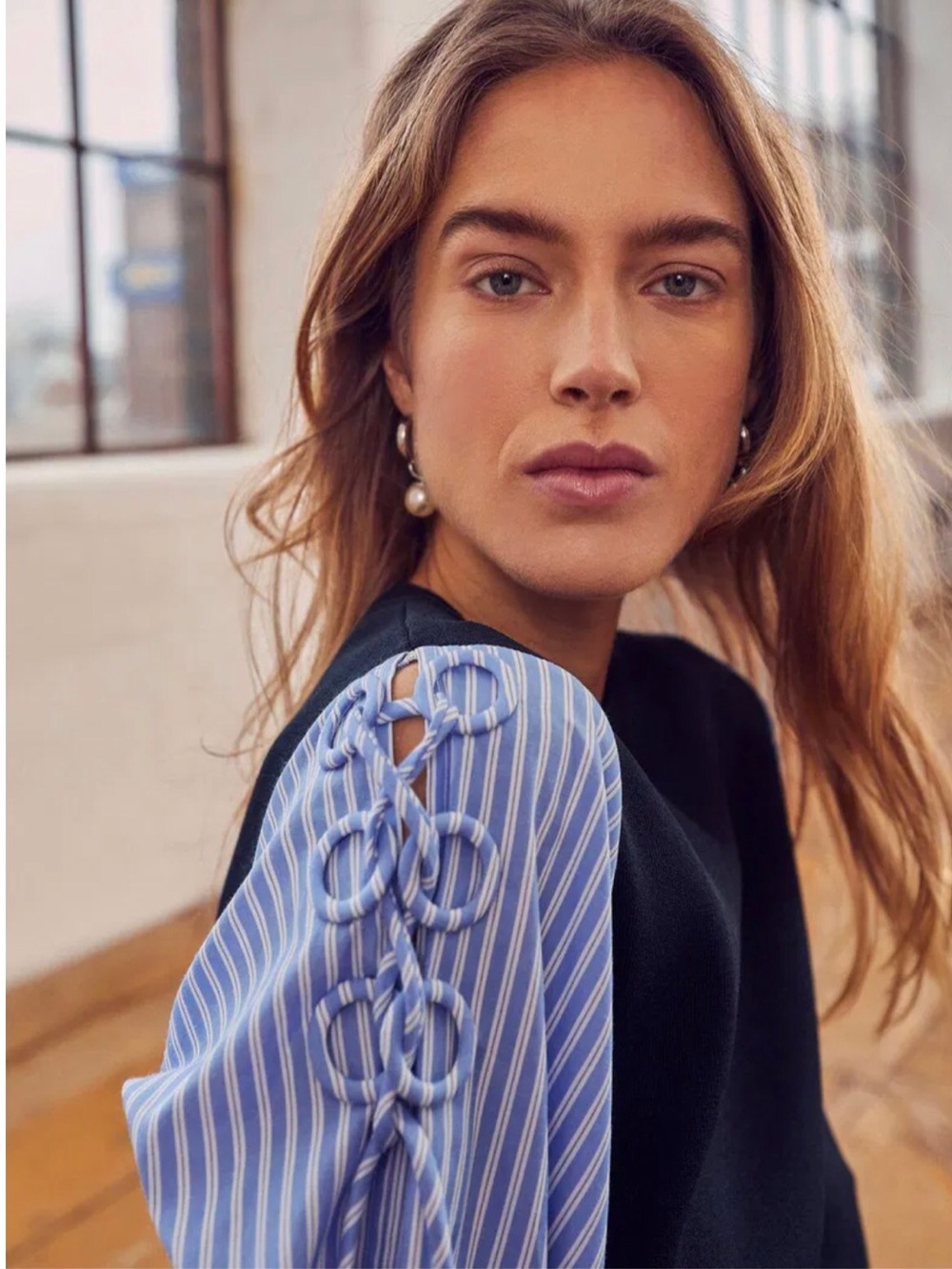 Black Knit Top with Blue Striped Puff Sleeve Detail